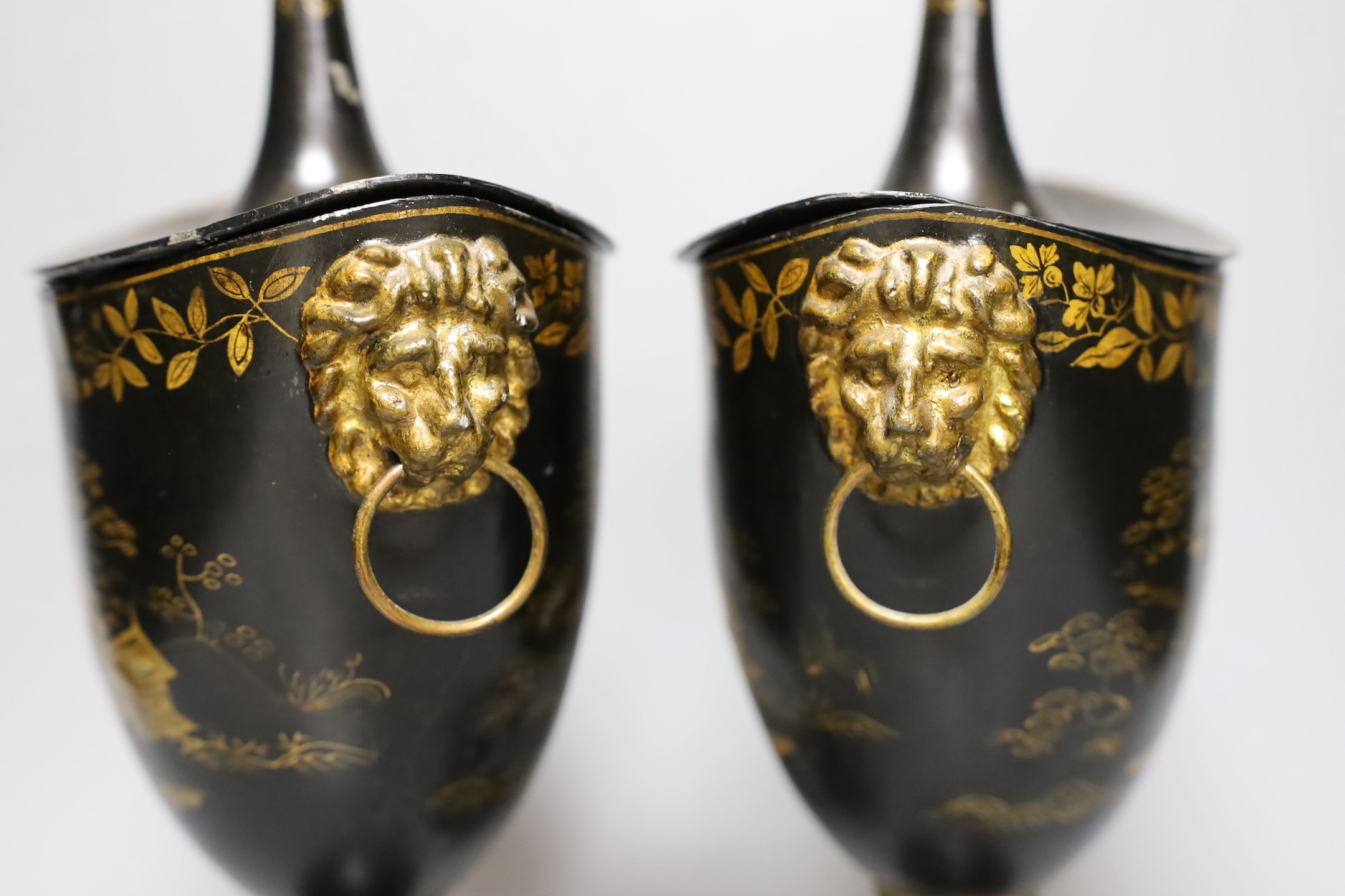 A pair of Japanned toleware urns and covers, 33cm tall